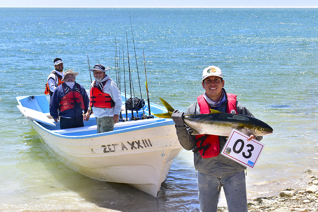 Team 3 displaing one of their yellowtail caught. 